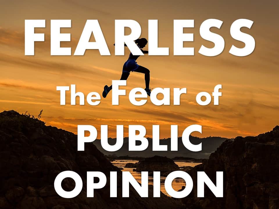 Fearless: the fear of Public Opinion, over a picture of a woman jumping a canyon